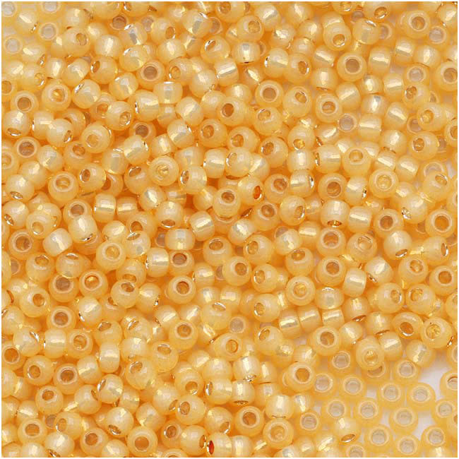 TOHO Round Seed Beads 11/0 2110, Silver Lined Milky Light Topaz